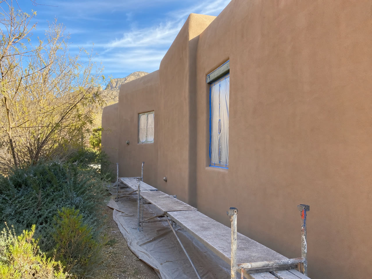 Fresh stucco finish coat on a Santa Fe adobe-style exterior